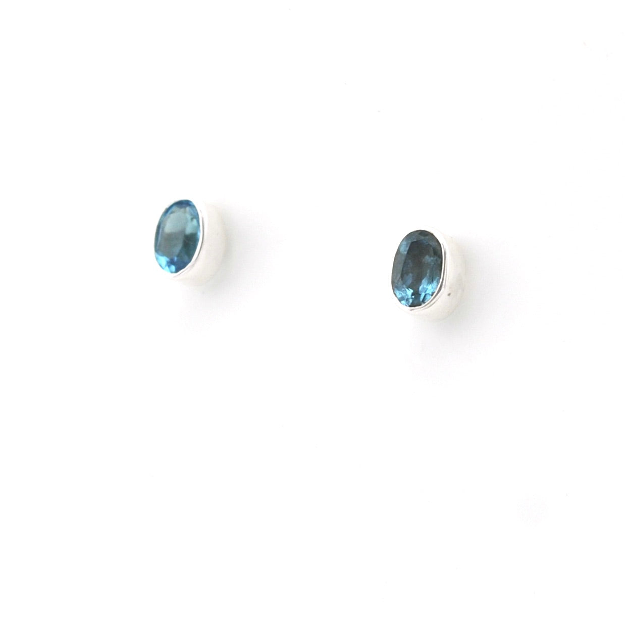 Pair of blue gemstone stud earrings on a white background