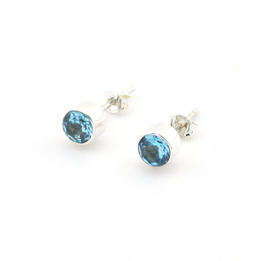 Pair of blue topaz stud earrings on a white background