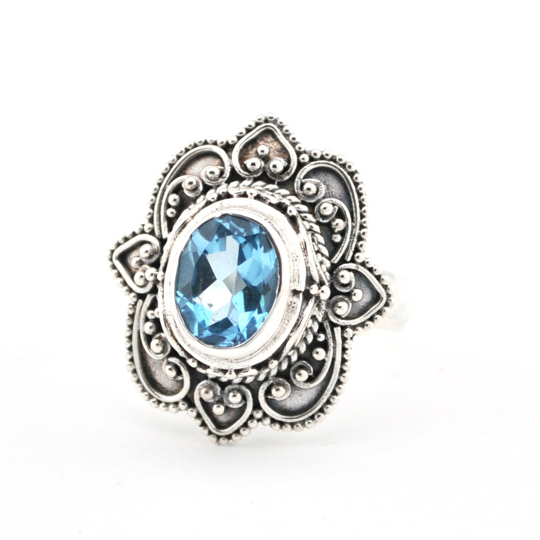 Silver ring with a blue gemstone on a white background