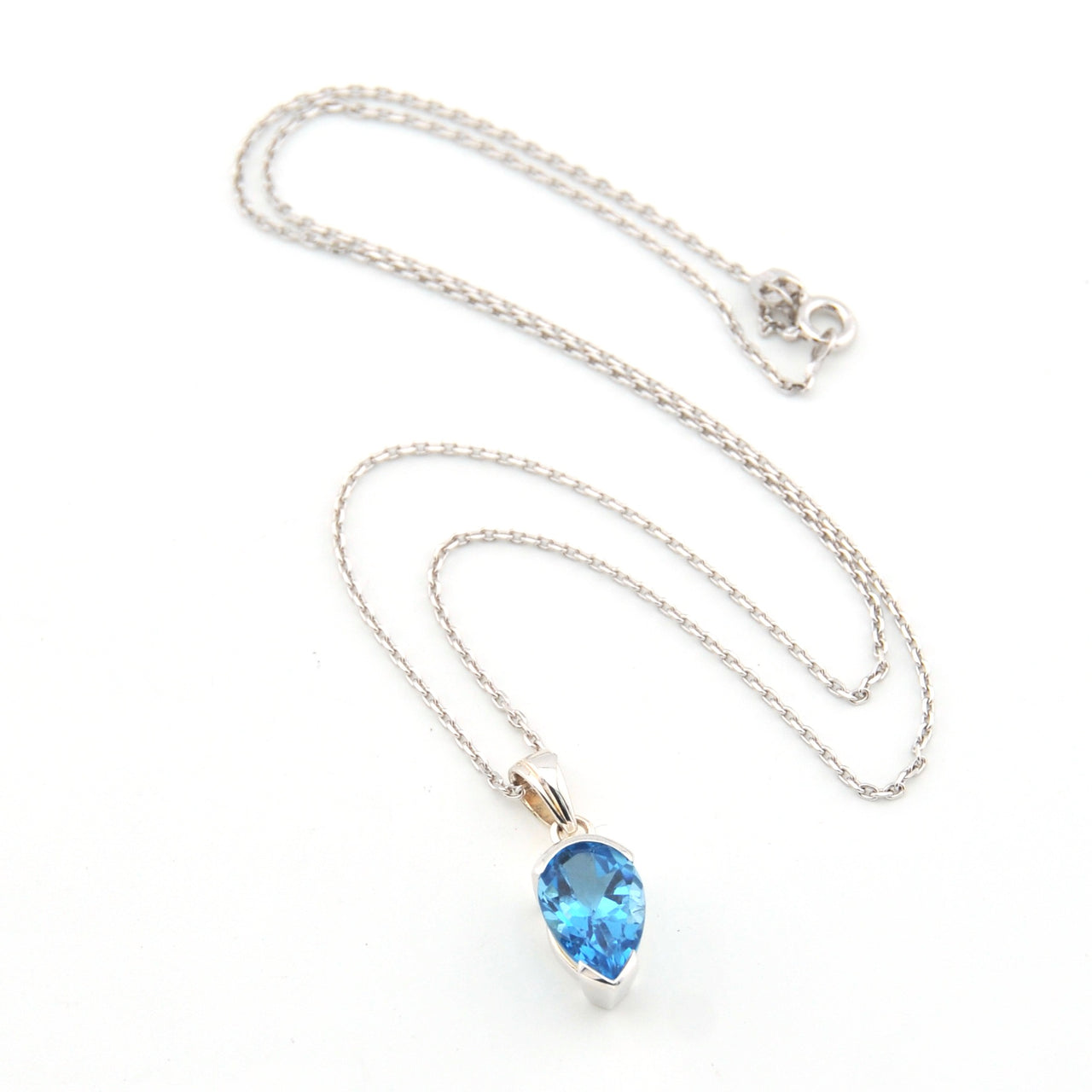 Necklace with a blue teardrop pendant on a white background
