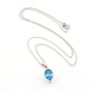 Necklace with a blue teardrop pendant on a white background