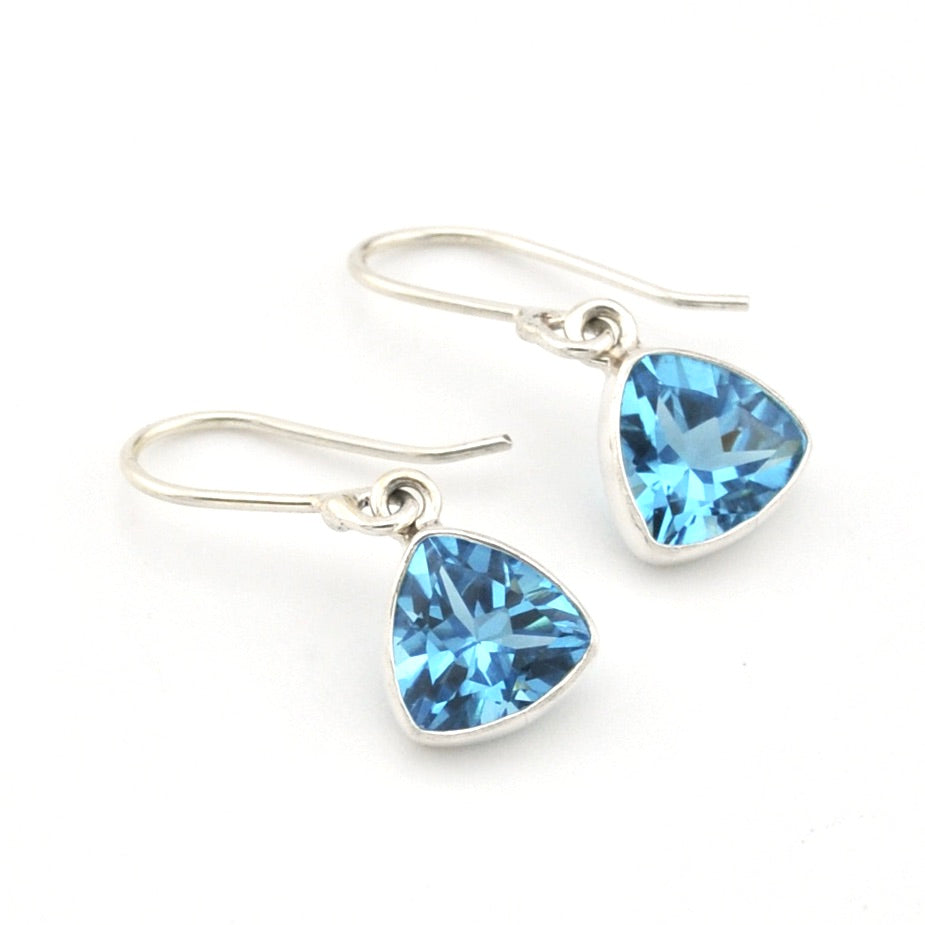 Blue topaz trillion dangle earrings on white background.