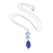 Necklace with blue topaz and blue sea glass pendant on a white background