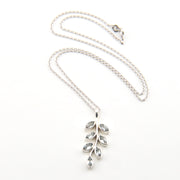 Silver necklace with leaf-shaped pendant on a white background