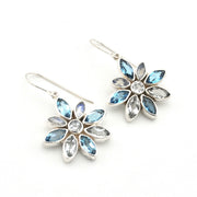 Handmade Sterling Silver Blue Topaz Moonstone Flower Earrings on white background