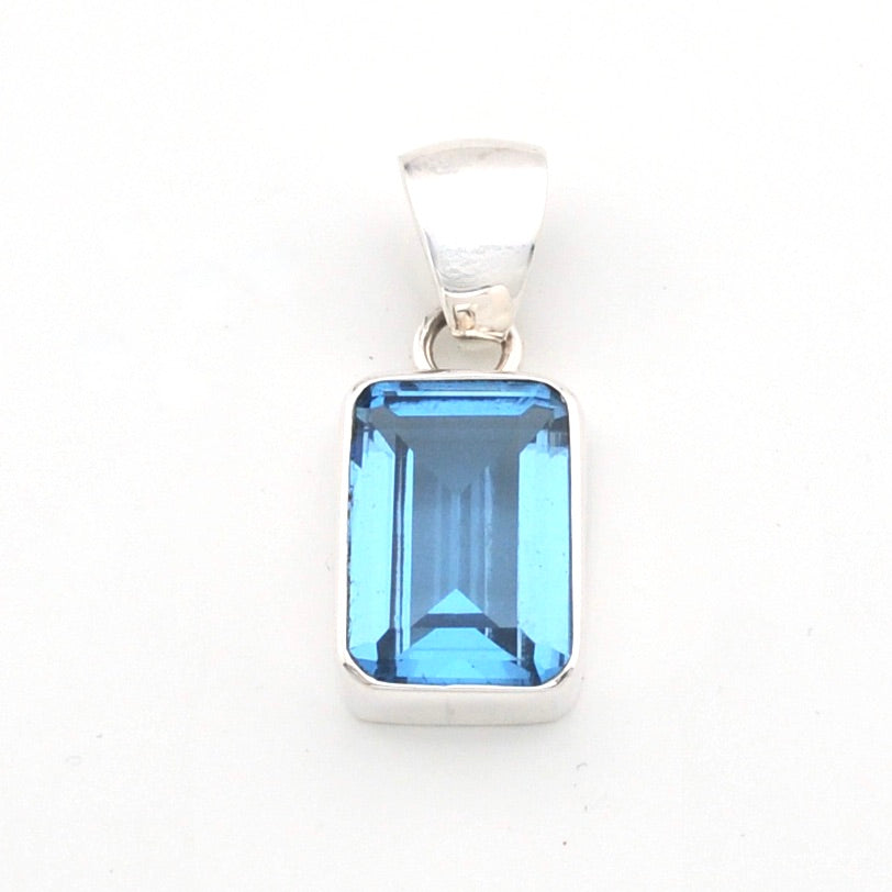 Blue gemstone pendant on a white background