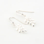 Silver branch-shaped earrings on a white background