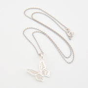 Silver butterfly necklace on a white background