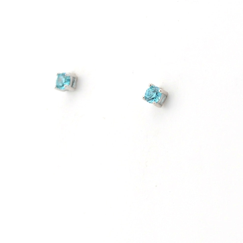 Pair of blue gemstone stud earrings on a white background