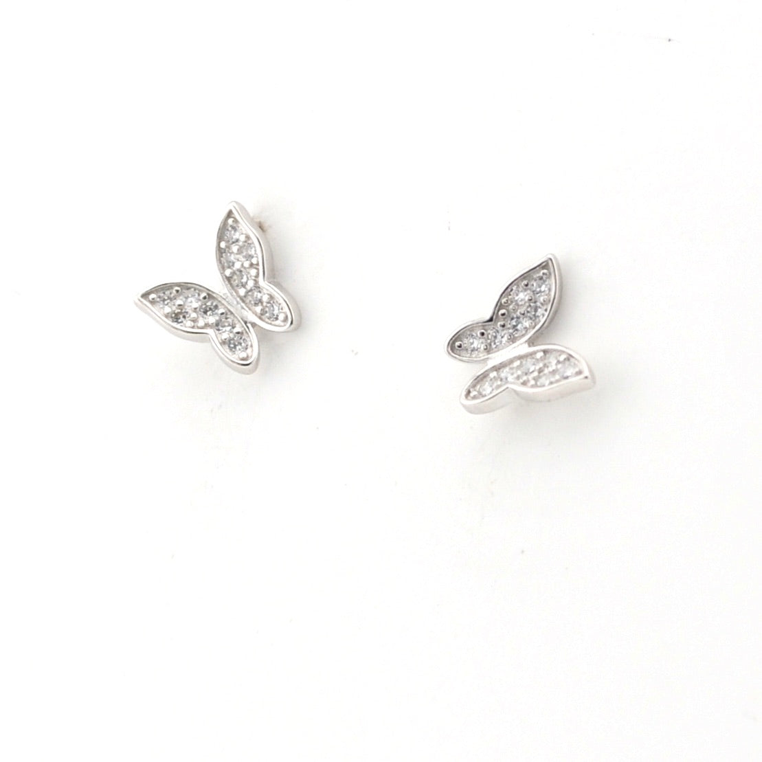 Pair of silver butterfly-shaped earrings on a white background