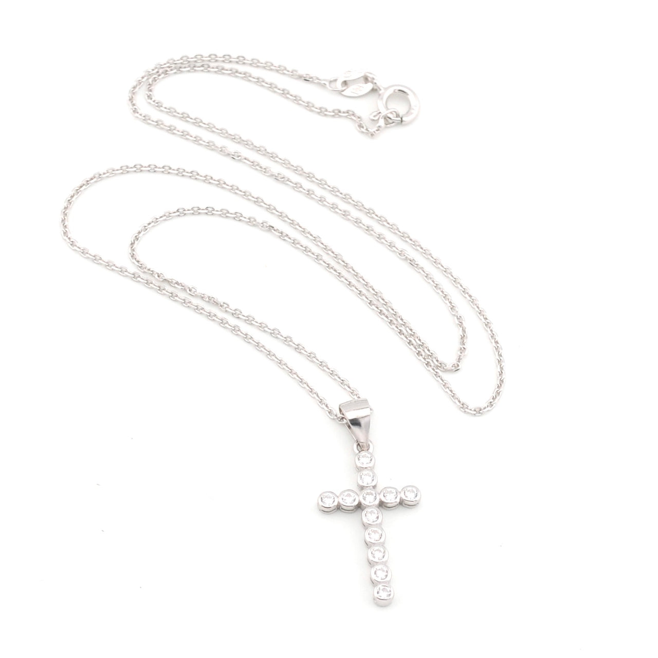 Silver cross necklace on a white background