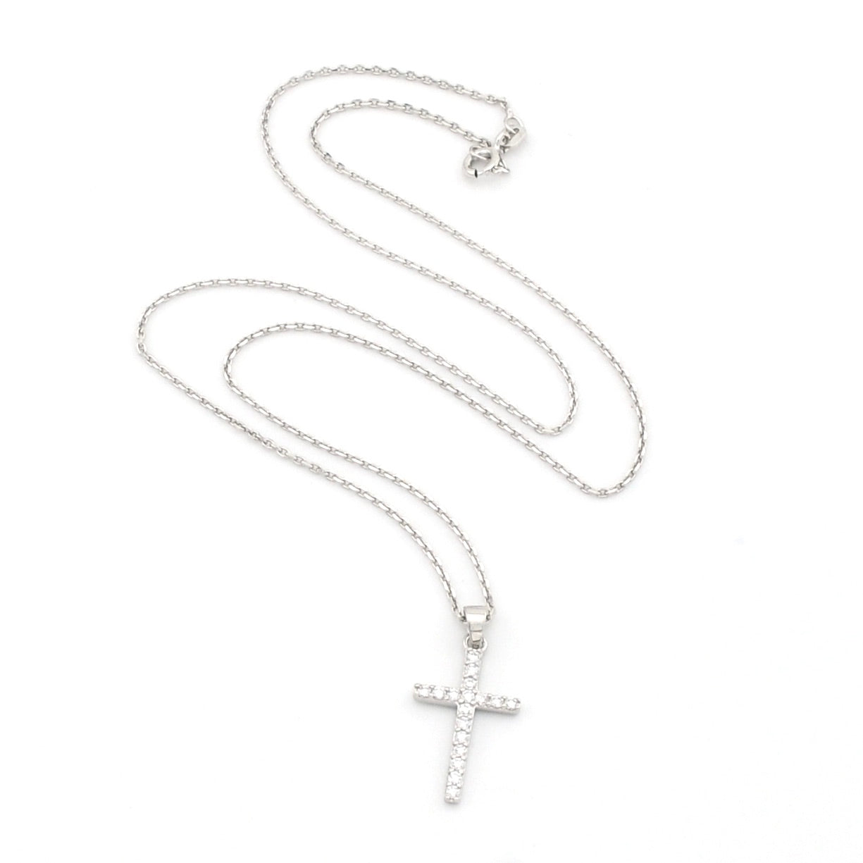 Silver cross necklace on a white background