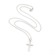 Silver cross necklace on a white background