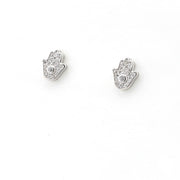 Silver hamsa hand earrings with clear stones on a white background