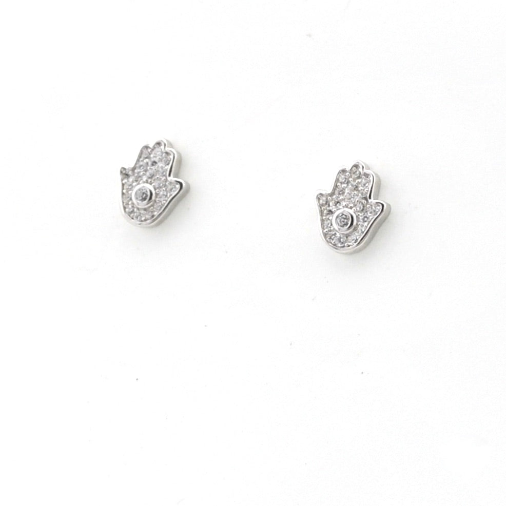 Silver hamsa hand earrings with clear stones on a white background