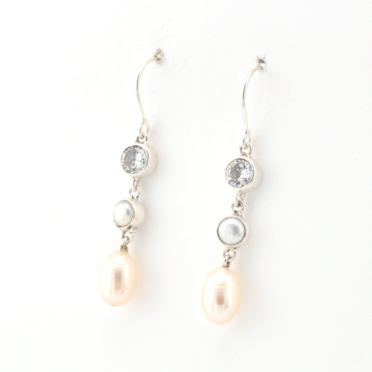 Pearl and crystal drop earrings on a white background