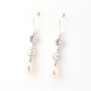 Pearl and crystal drop earrings on a white background