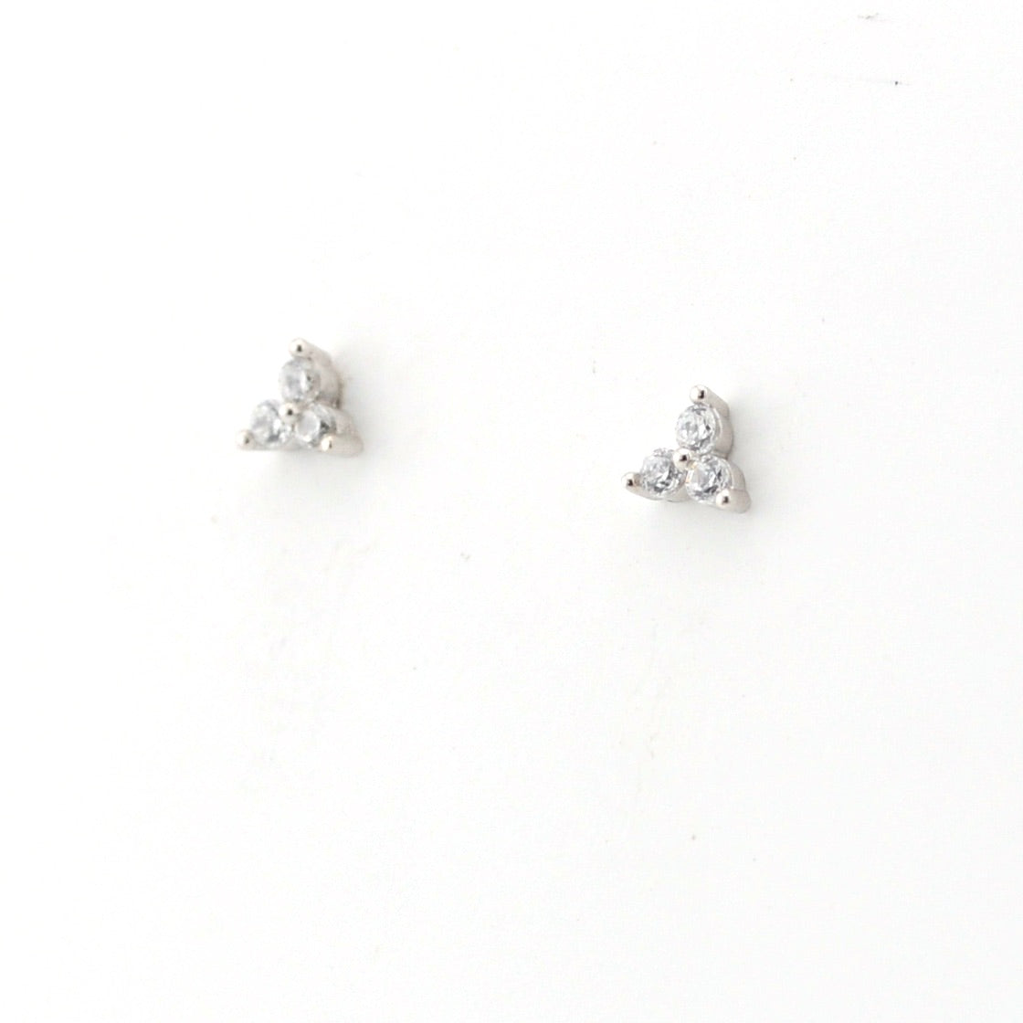 Pair of silver stud earrings on a white background