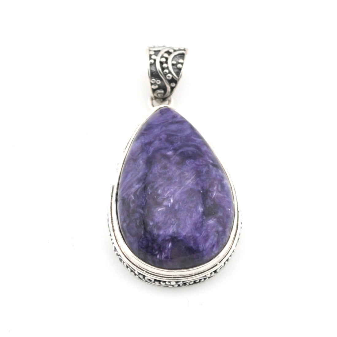 Purple teardrop pendant with silver setting on a white background