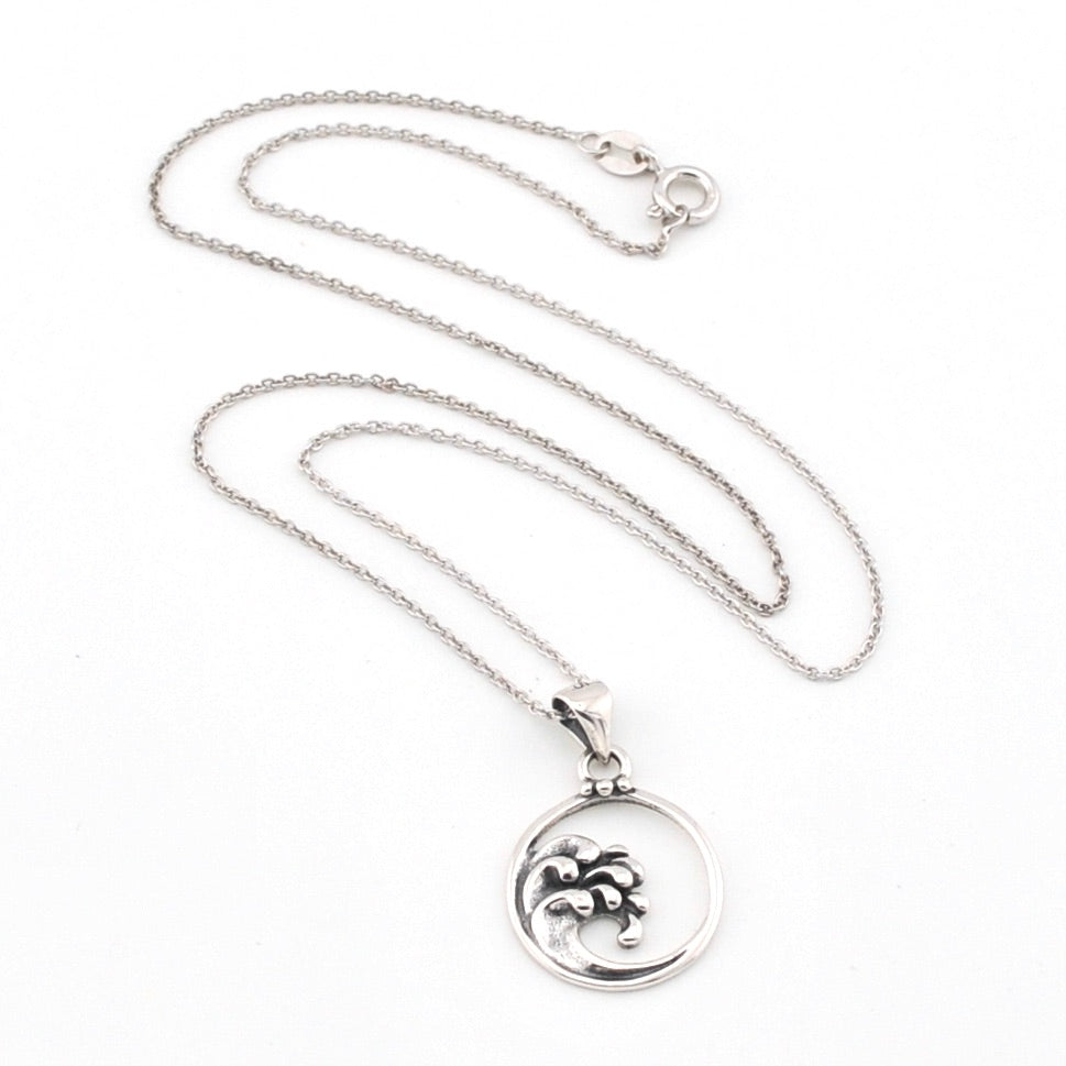Silver necklace with a round pendant on a white background