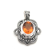 Silver pendant with an orange gemstone on a white background