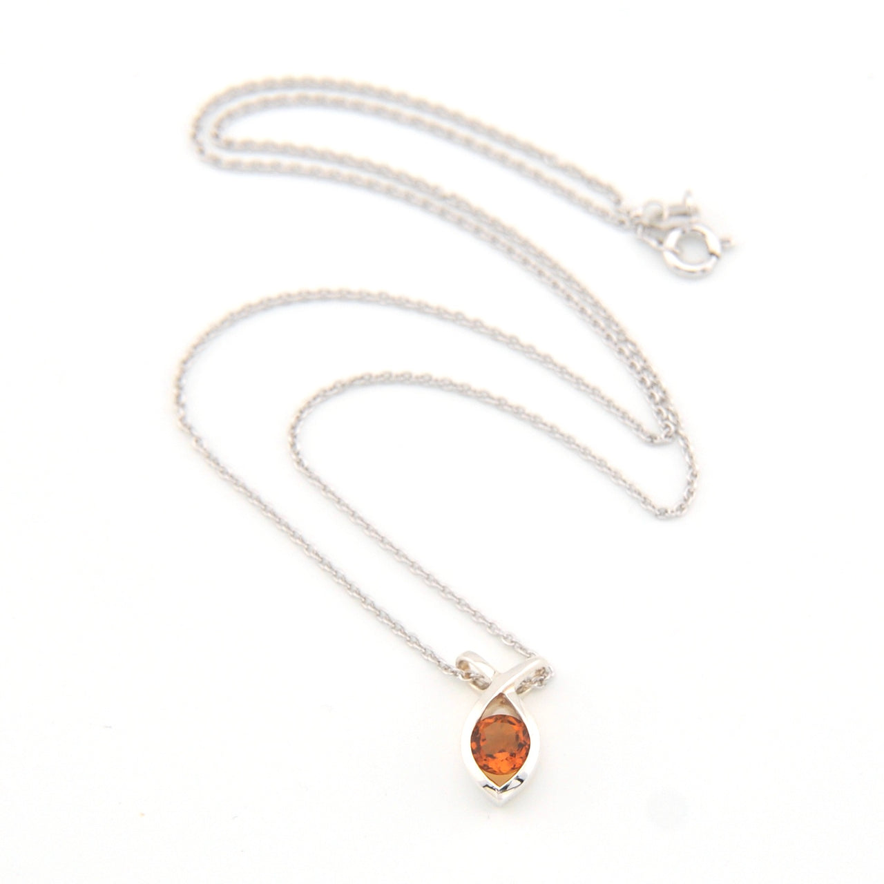 Silver necklace with a round-shaped orange gemstone on a white background