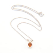 Silver necklace with a round-shaped orange gemstone on a white background