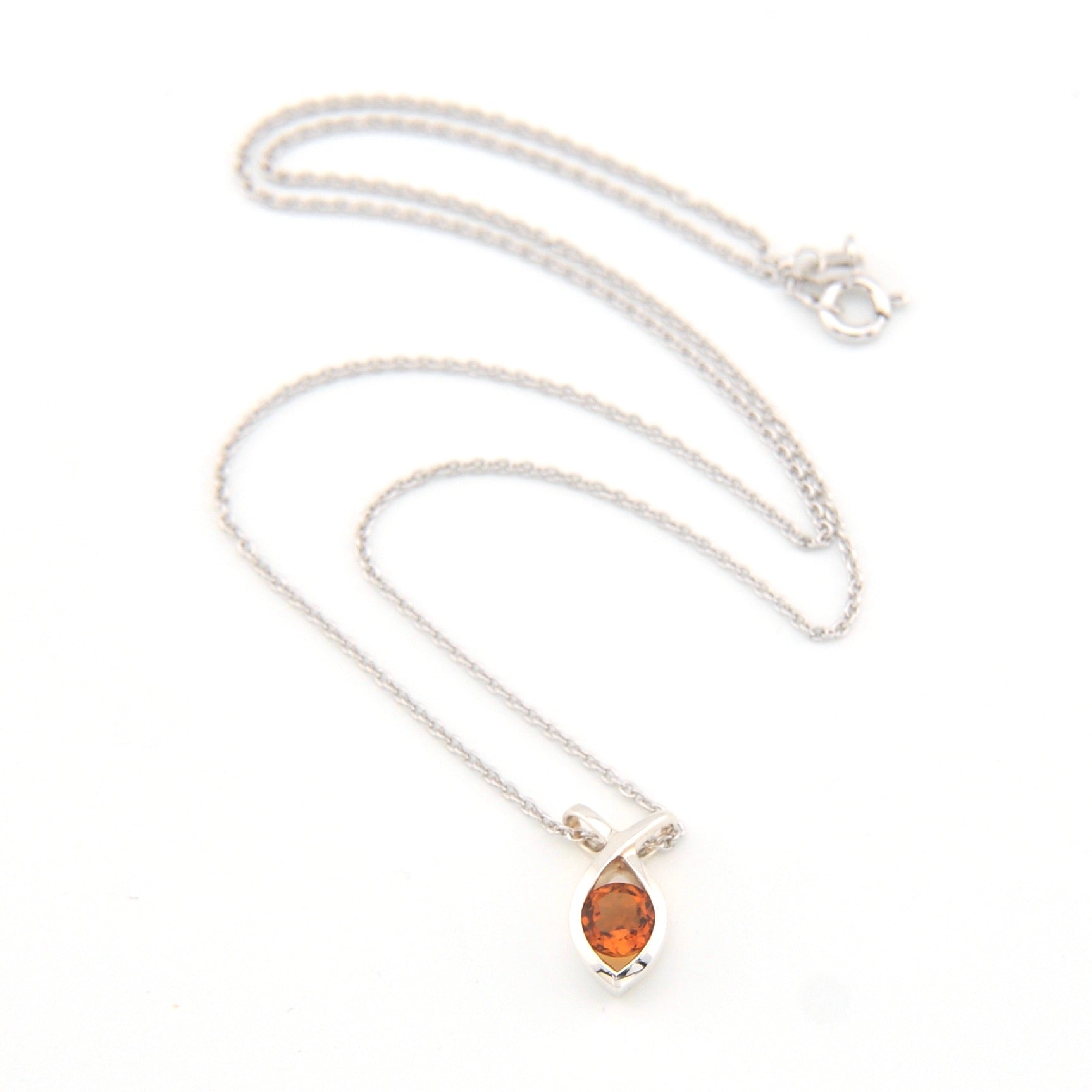 Silver necklace with a round-shaped orange gemstone on a white background