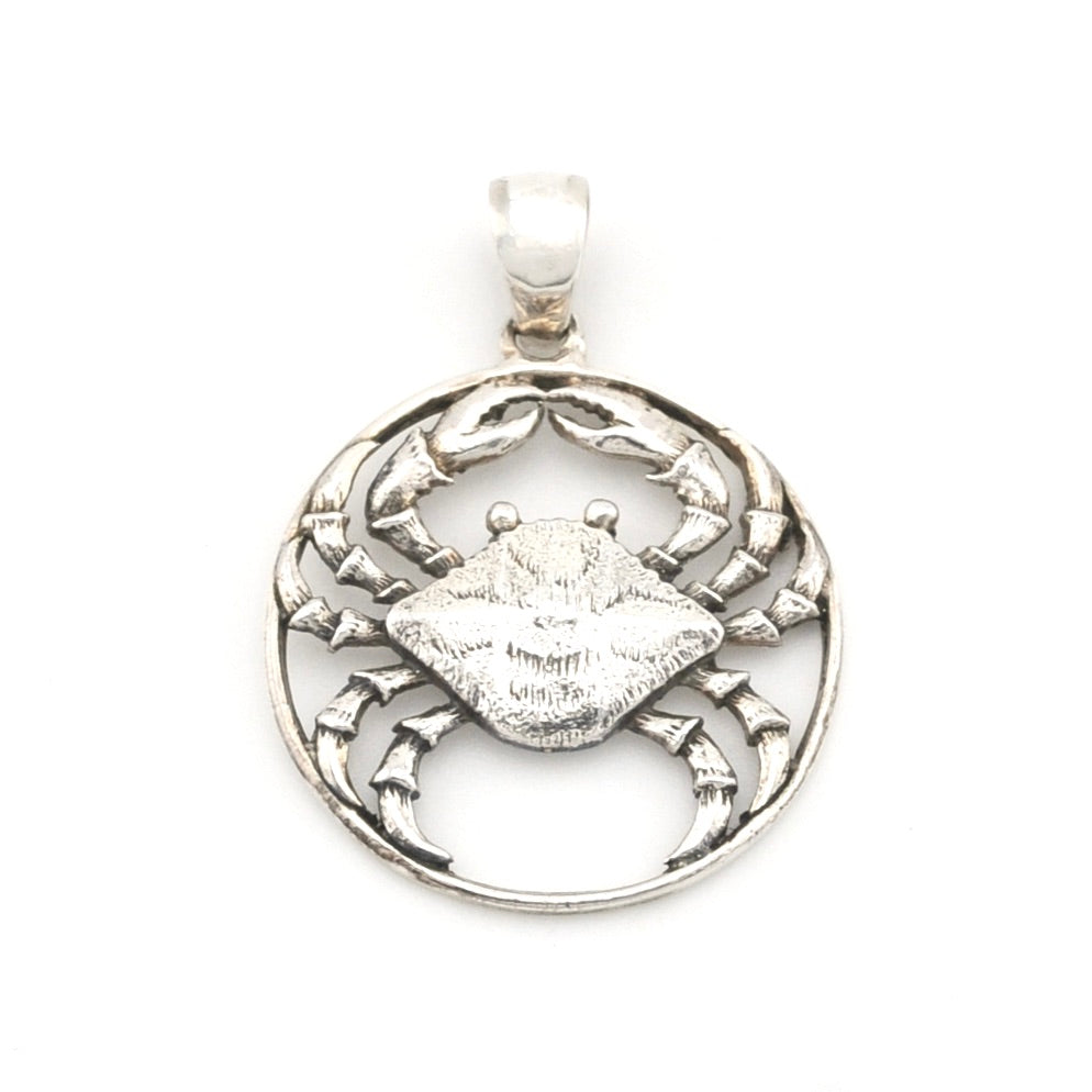 Silver crab pendant on a white background
