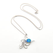 Silver necklace with a blue pendant on a white background