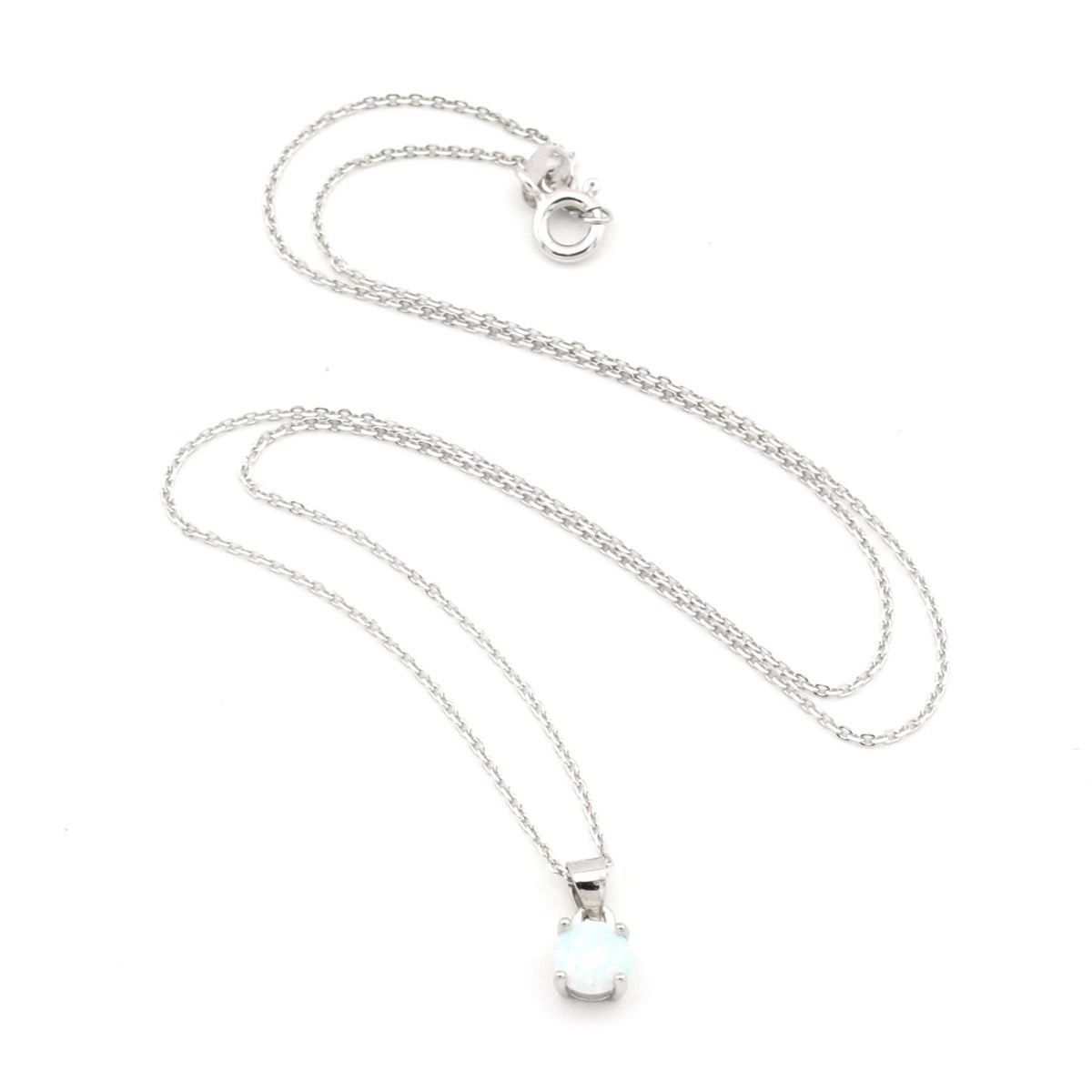 A silver chain necklace with a small oval white opal pendant, displayed on a clean white background.