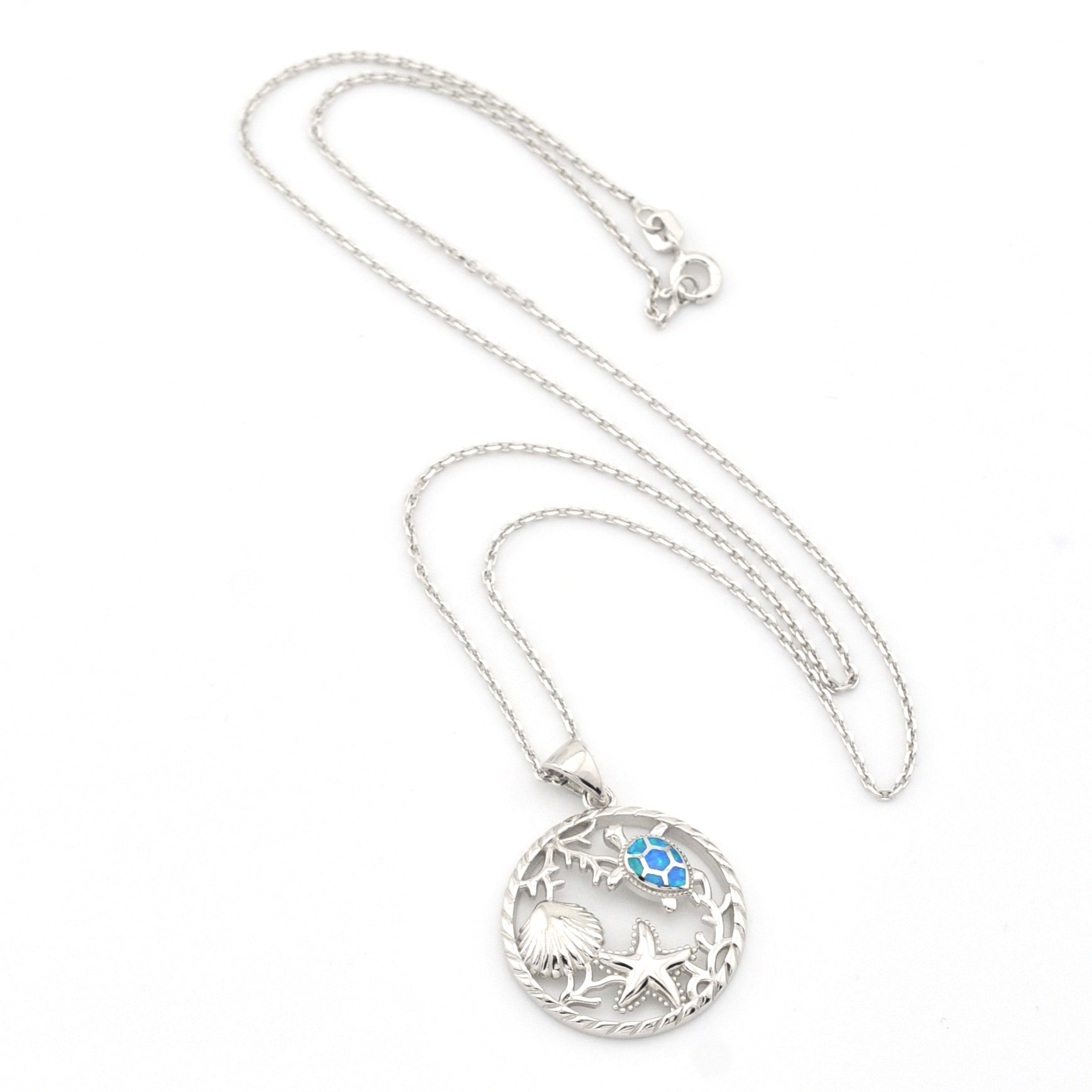 Silver necklace with a round pendant featuring a blue gemstone on a white background