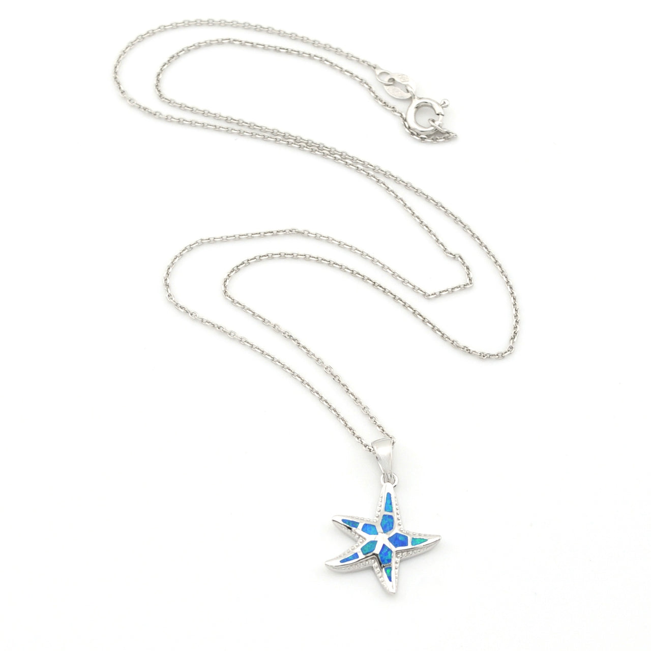 Star-shaped pendant necklace with blue accents on a white background