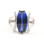 Silver ring with a blue gemstone on a white background