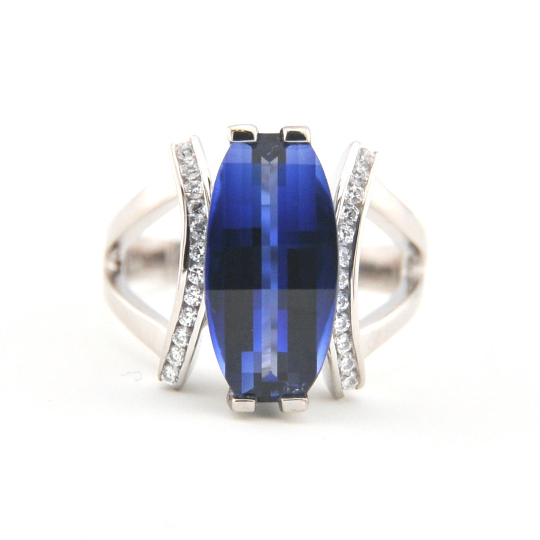 Silver ring with a blue gemstone on a white background