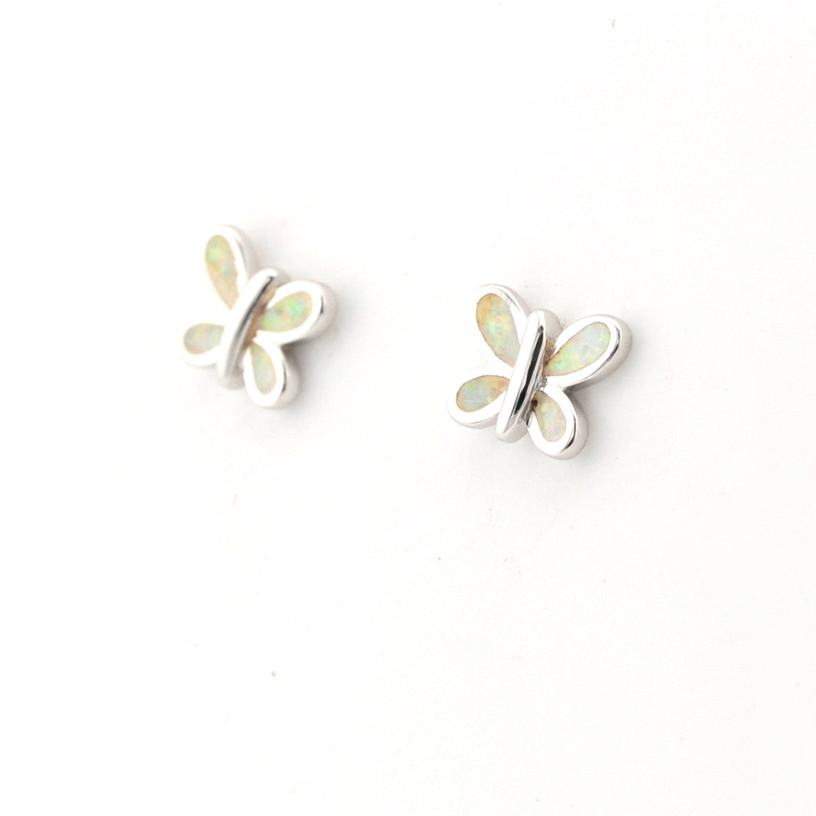 Butterfly-shaped earrings with opal stones on a white background