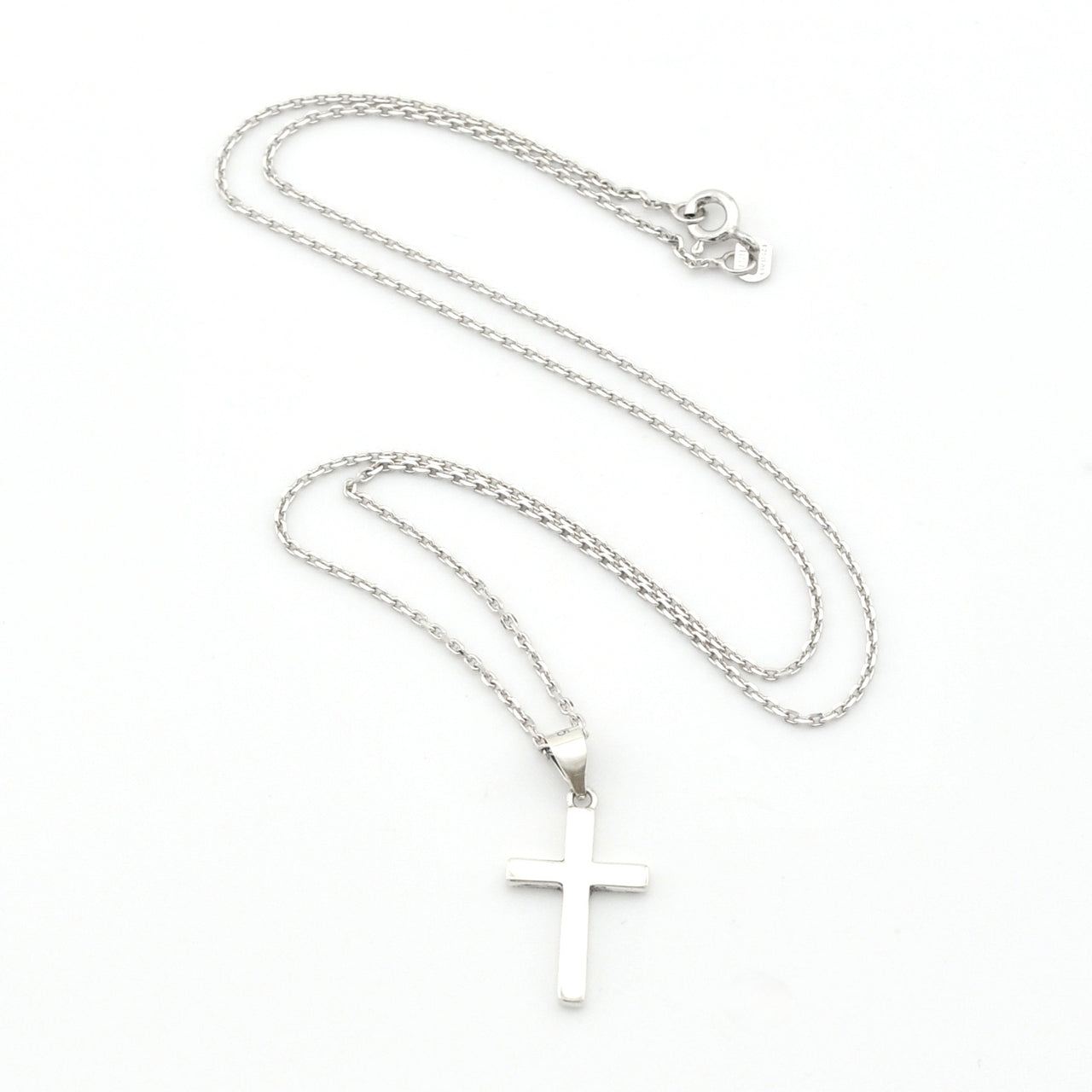 Silver cross necklace on a white background