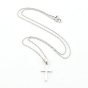 Silver cross necklace on a white background