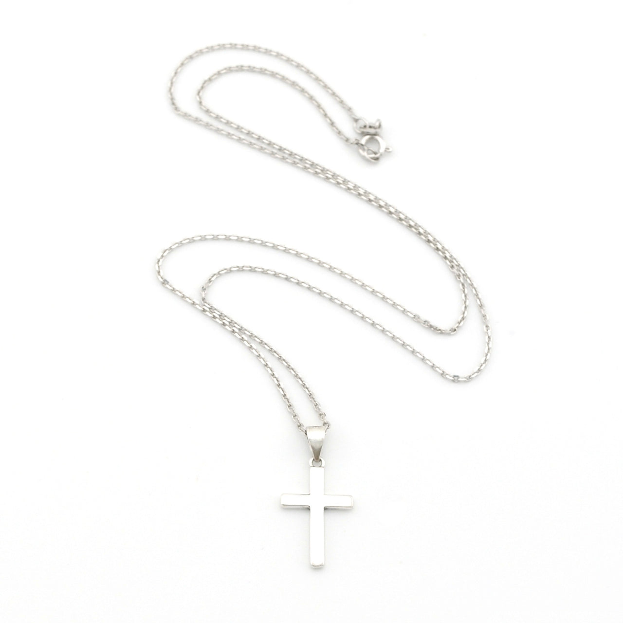 Silver cross necklace on a white background