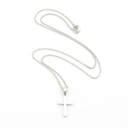 Silver cross necklace on a white background