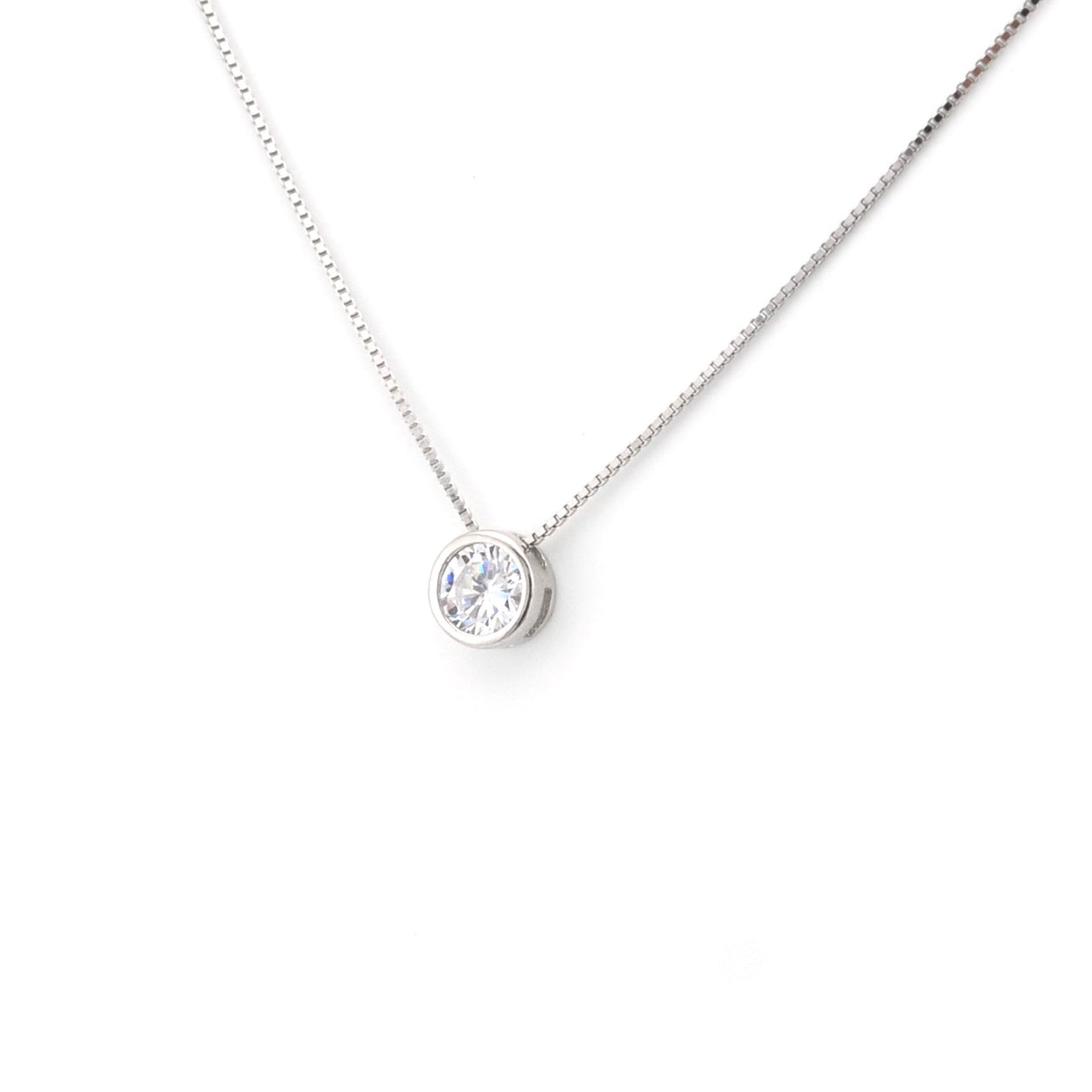 Silver necklace with a round pendant on a white background