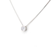 Silver necklace with a round pendant on a white background