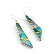 A pair of silver dangle earrings with geometric, arrowhead-shaped green iridescent dichroic glass, shown on a plain white background.