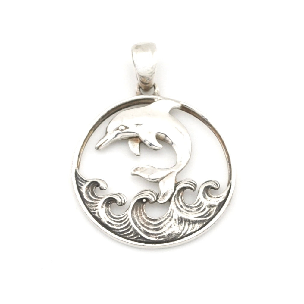Silver pendant with a dolphin design on a white background
