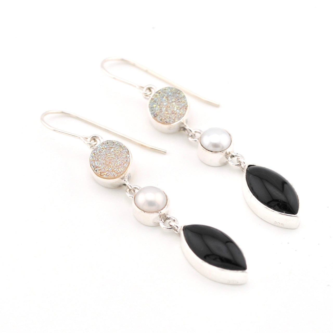 Earrings with black, white, and gold stones on a white background