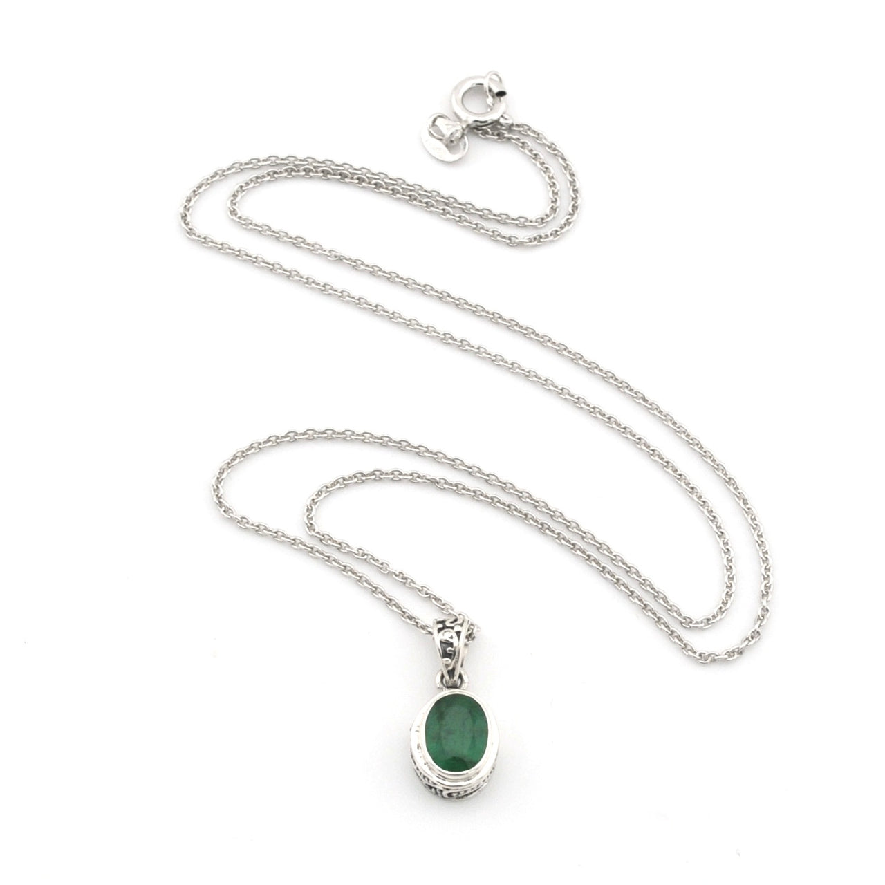 Silver necklace with a green pendant on a white background