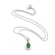 Silver necklace with a green pendant on a white background