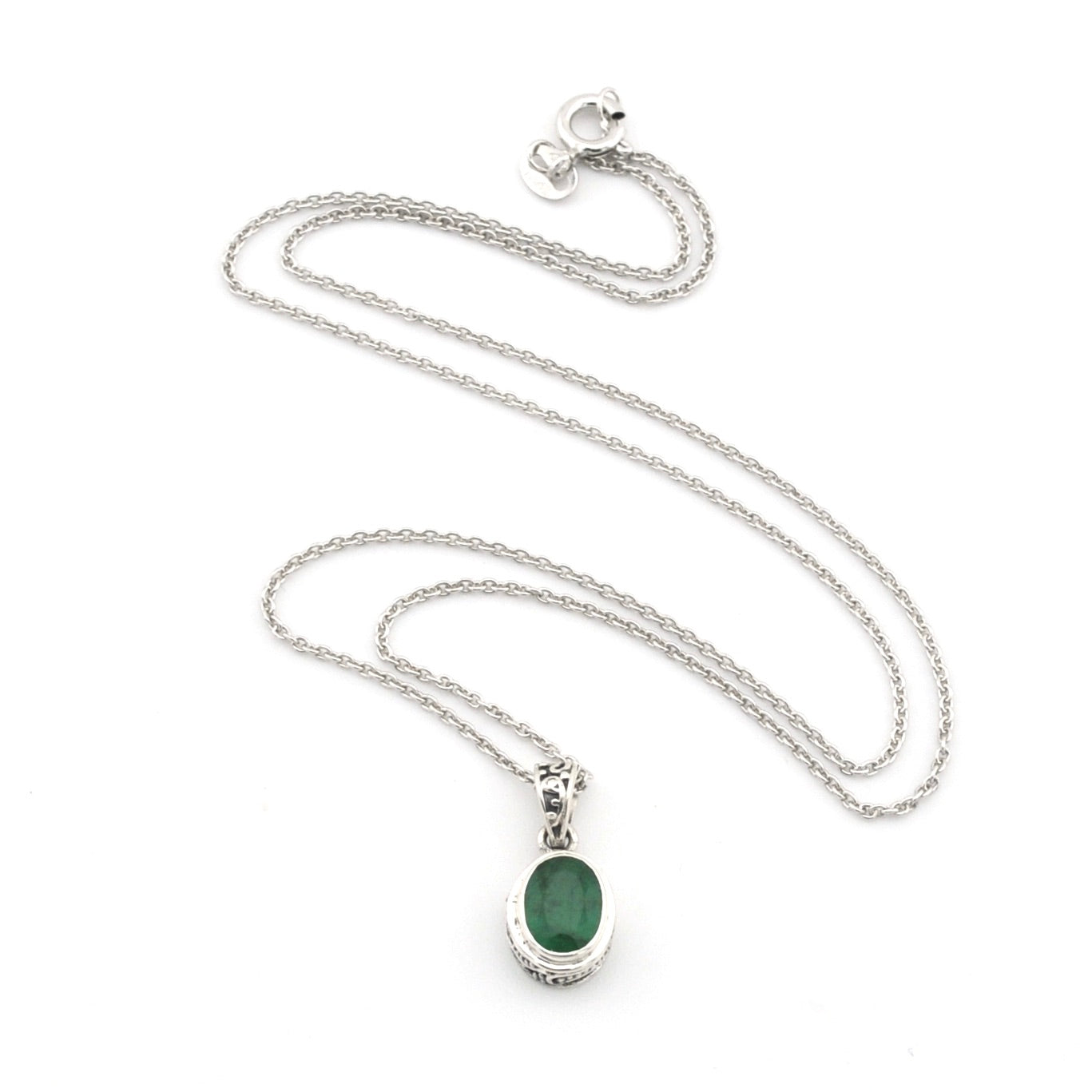 Silver necklace with a green pendant on a white background