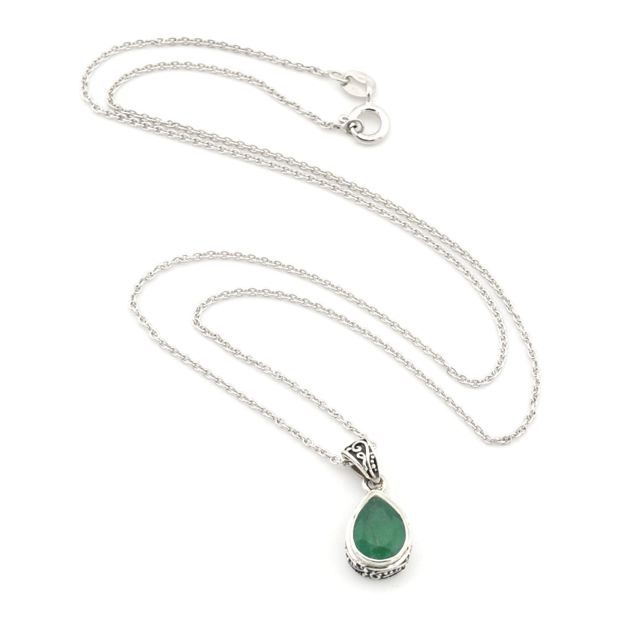 Silver necklace with a green teardrop pendant on a white background
