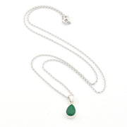 Necklace with a green teardrop pendant on a white background